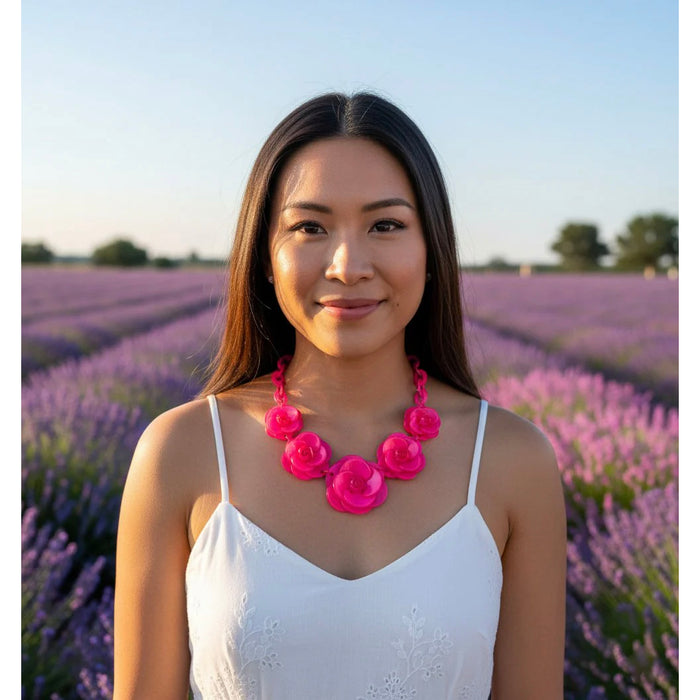 Woman wearing a pink floral necklace in a lavender field