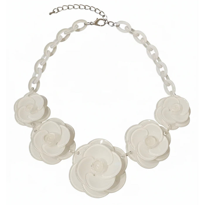Necklace with white floral pendants on a white background