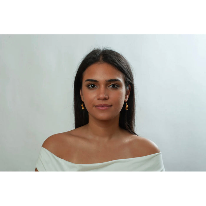 Woman wearing a white off-shoulder top against a plain background