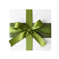Gift box with a green ribbon and a light and dark green striped sleeve on a white background