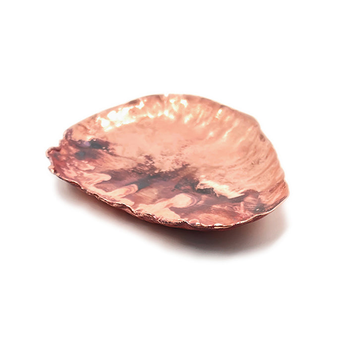 Brass tray with a hammered texture on a white background