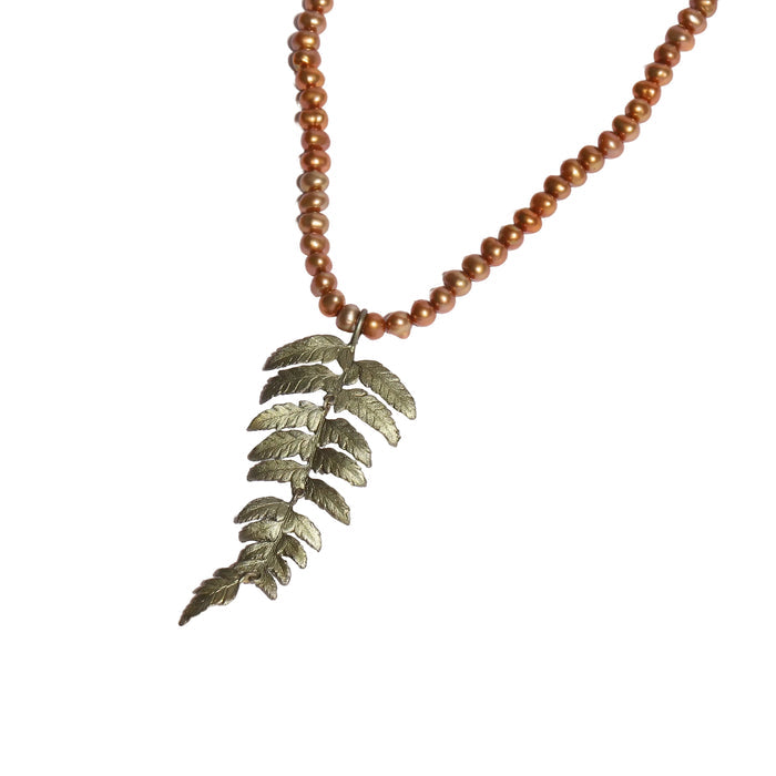 Necklace with leaf pendant and pearl beads