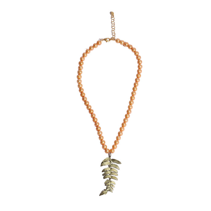 Necklace with pearl beads and a green leaf pendant