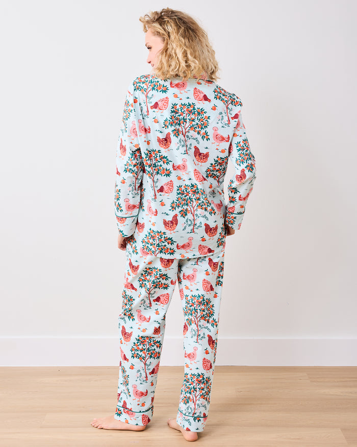 Back view of the long pajama set with a chicken and fruit-tree print on a light blue background