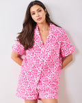 Front view of the party-pink short pajama set with cowboy boot and floral print.