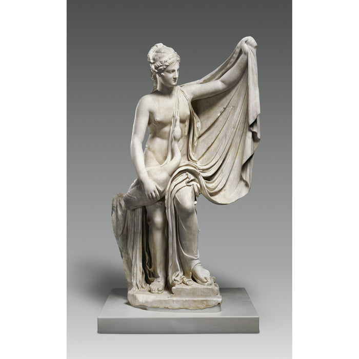 Statue of a draped figure on a gray background