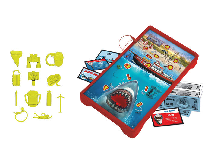 Board game set with shark-themed board, cards, and plastic pieces on a white background